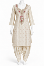 A cream-colored Indian ethnic suit set displayed on a white mannequin, featuring a kurta with red and gold floral embroidery at the neckline and matching beige patola-style pants.