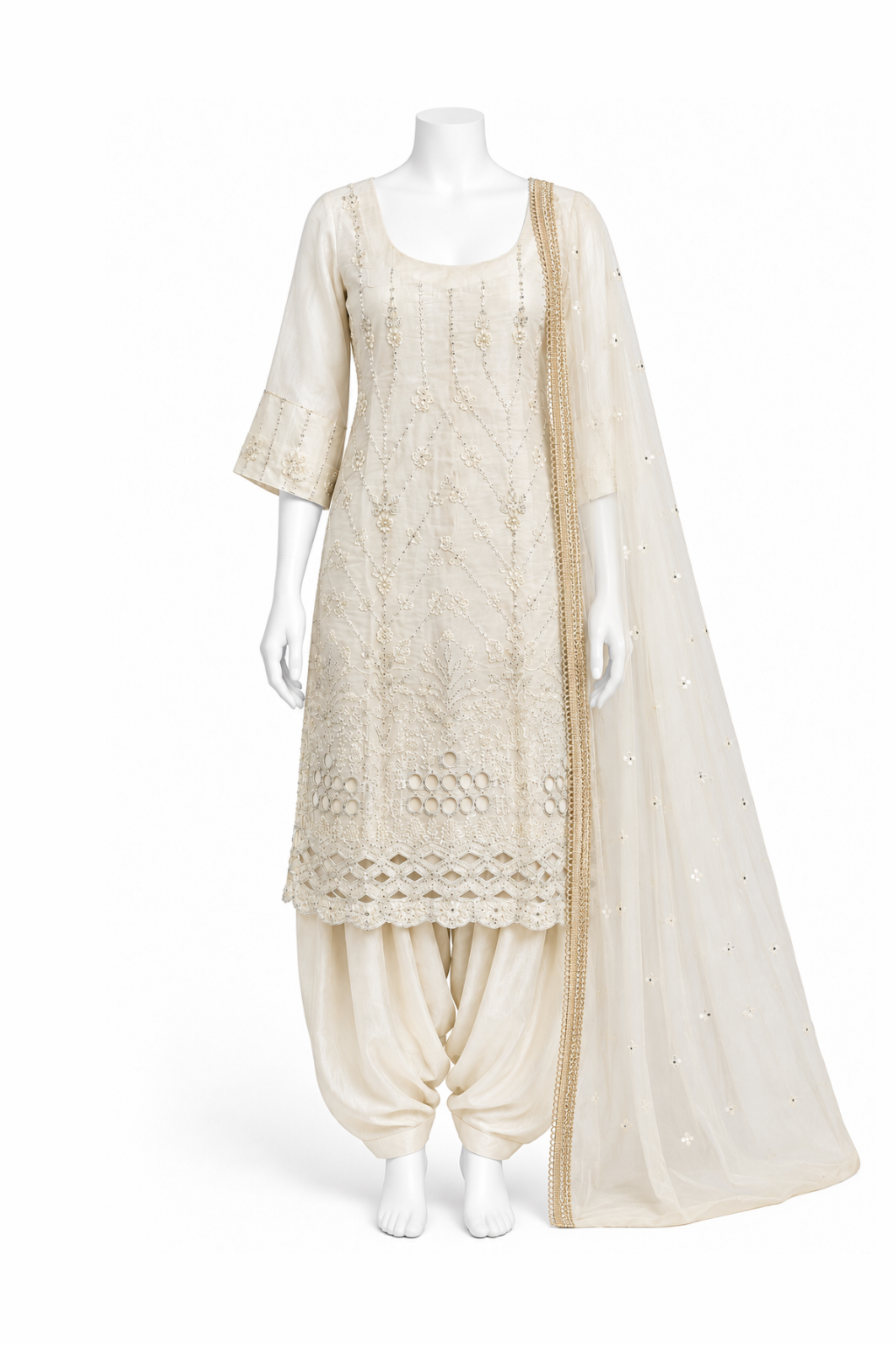 An off-white/cream traditional South Asian outfit displayed on a white mannequin, featuring a heavily embroidered kurta, matching harem pants, and a sheer embroidered dupatta.