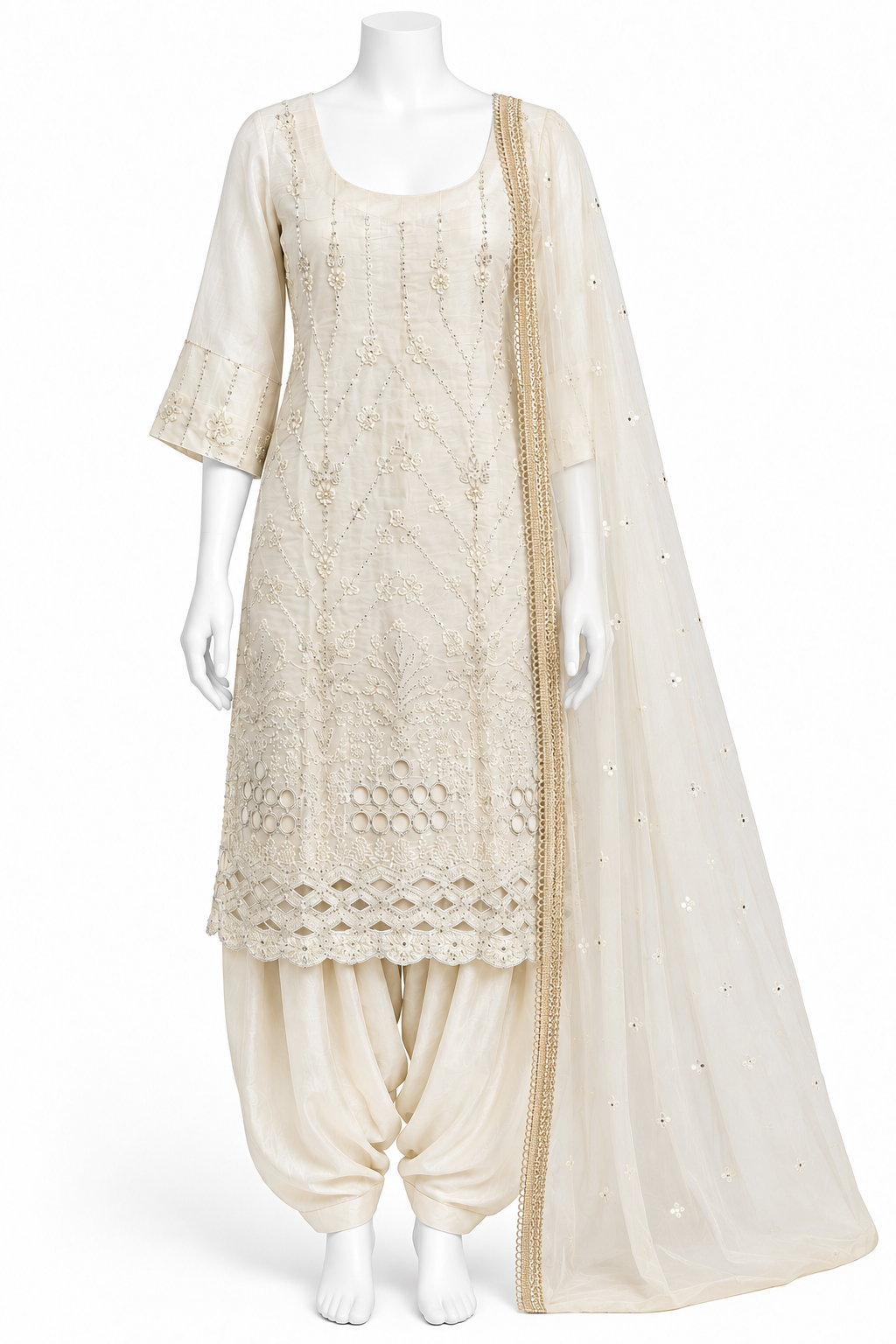 An off-white/cream traditional Indian suit set displayed on a white mannequin, featuring a heavily embroidered kurta, matching harem pants, and a sheer embroidered dupatta.