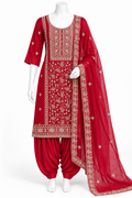 A red traditional Indian salwar kameez suit displayed on a white mannequin, featuring a heavily embroidered kameez kurta, matching red patina pants, and a sheer red dupatta with gold borders.