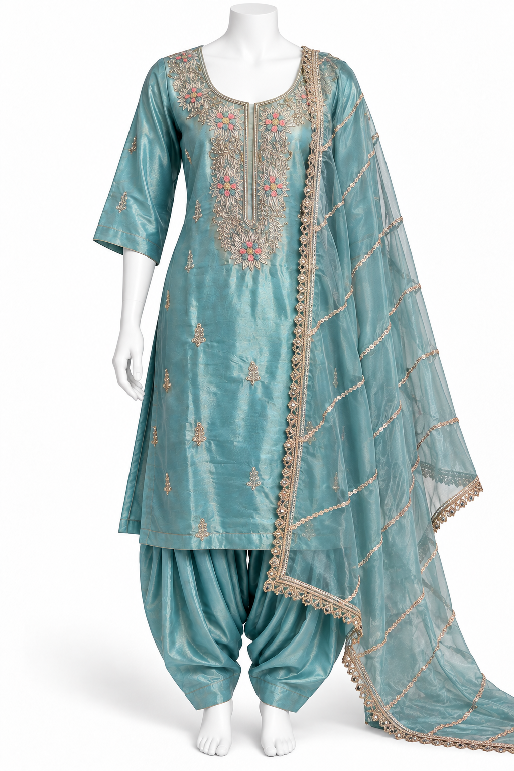 A three-piece traditional Indian salwar kameez suit displayed on a white mannequin. The set features a metallic teal blue-green kameez top with gold and pink floral embroidery, matching teal blue-green pants, and a sheer teal dupatta with gold borders and stripes.