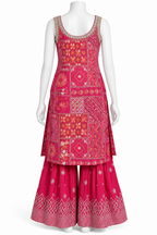 A sleeveless kurta and flared pants set displayed on a white mannequin. The outfit features a vibrant pink and magenta base with intricate multicolor patchwork embroidery and white geometric patterns on the flared pants.