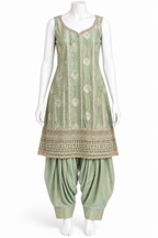 A sage green traditional Indian outfit displayed on a white mannequin, featuring a sleeveless kurta with gold embroidery and a flared pant leg.