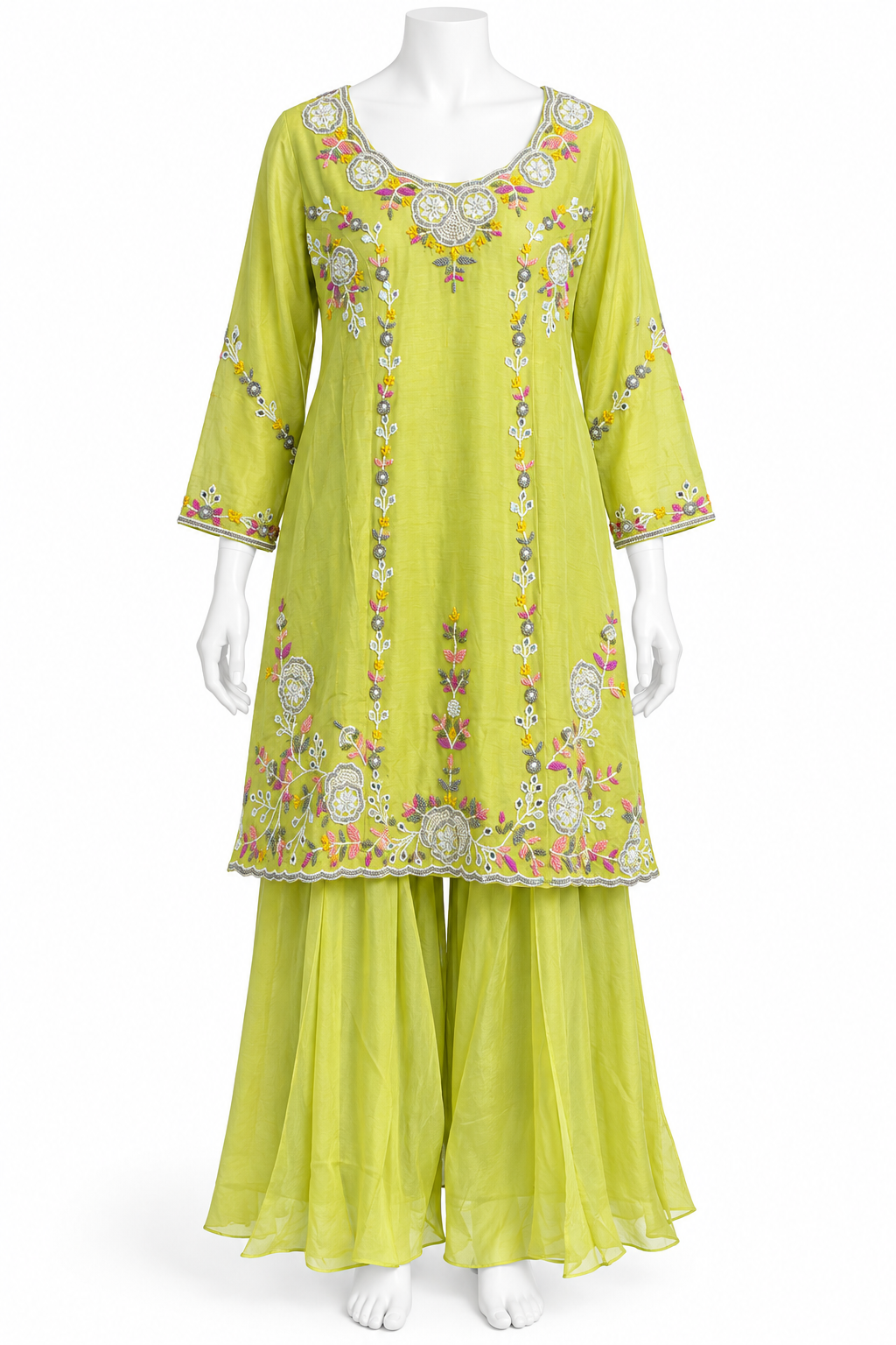 A lime green three-piece salwar kameez suit set displayed on a white mannequin. The set includes a long-sleeved embroidered kameez top, matching wide-leg trousers, and a coordinating waist scarf.