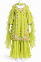 A lime green traditional outfit displayed on a white mannequin, featuring a long-sleeved embroidered kurta with sheer ruffled sleeves and matching wide-leg pants.
