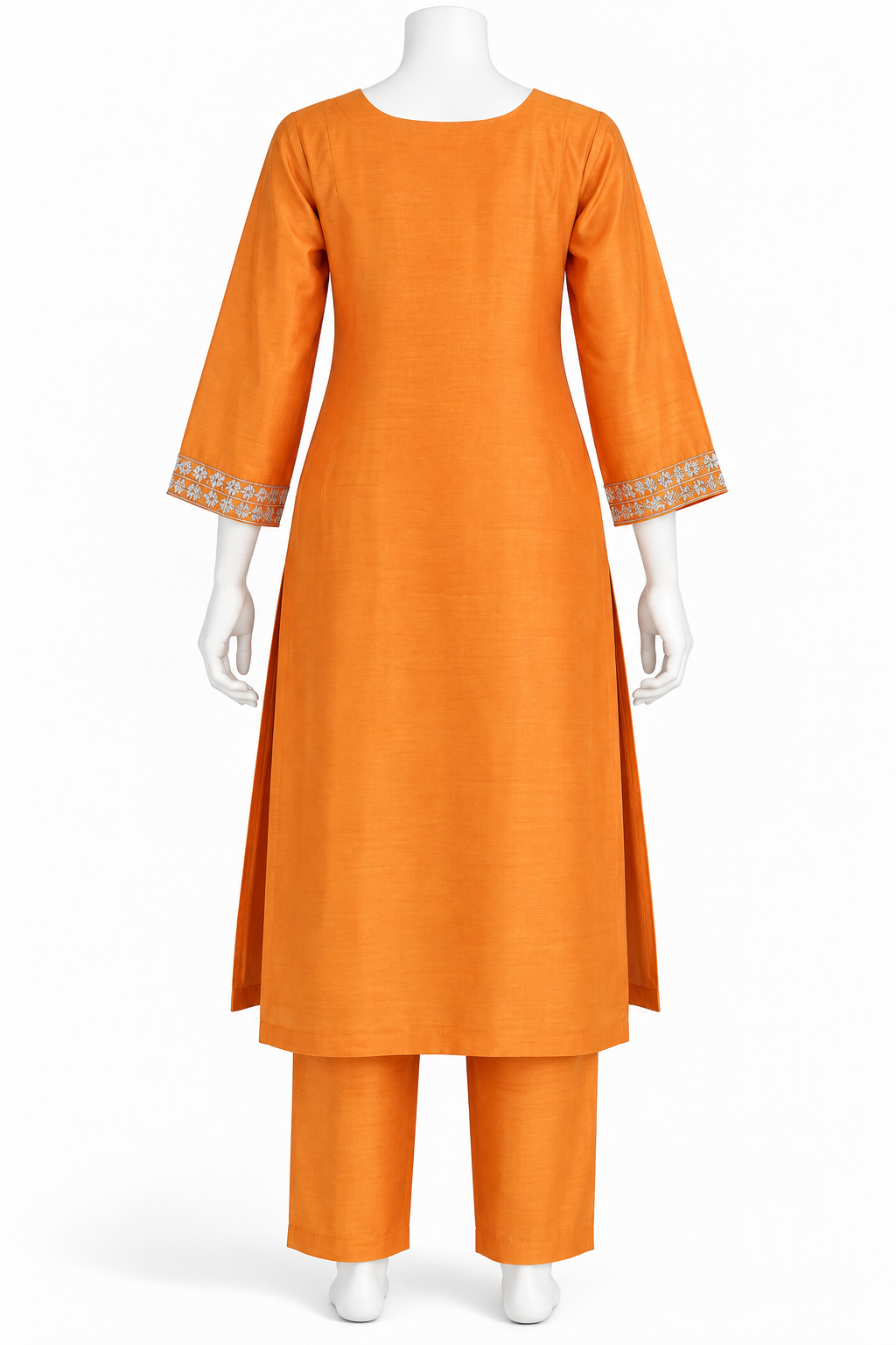 An orange three-piece kurta set displayed on a white mannequin against a plain white background. The set includes a long-sleeved kurta with decorative embroidered cuffs, matching straight trousers, and a coordinating belt.