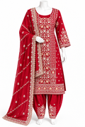 A red Indian ethnic suit set displayed on a white mannequin, featuring a heavily embroidered kurta, matching pants, and a coordinating dupatta with intricate gold and beige floral patterns.