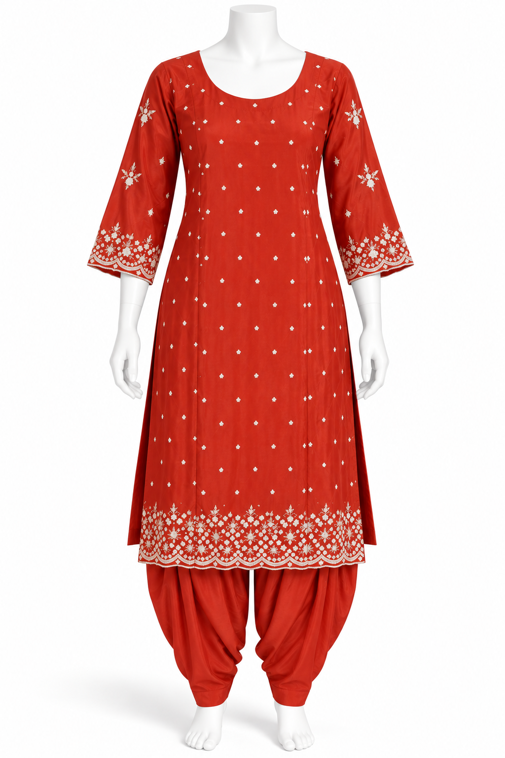 A red salwar kameez suit set displayed on a white mannequin, featuring a kurta with white embroidered patterns and a matching red patola pant.