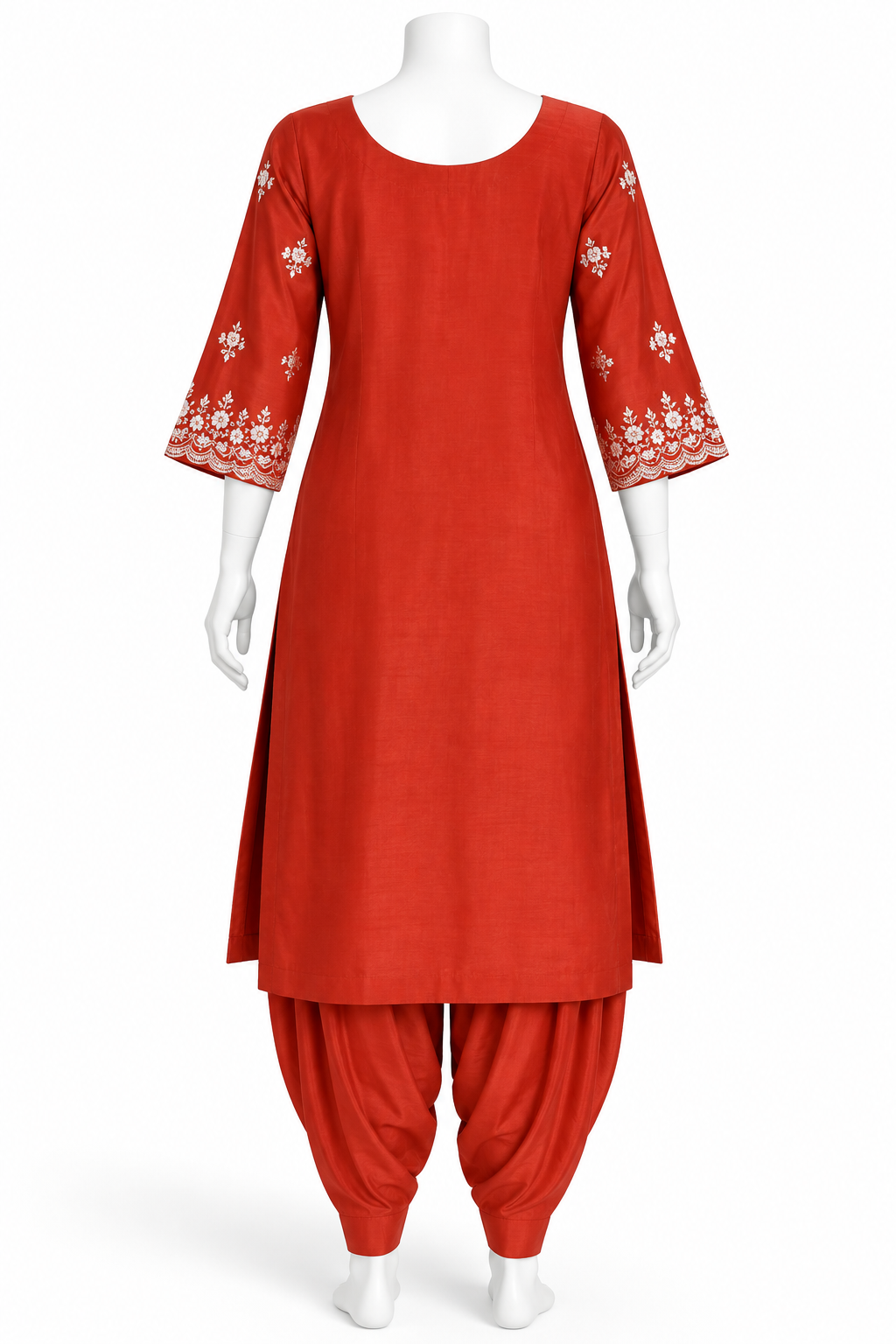 A red kurta and pant set displayed on a white mannequin against a plain white background. The kurta has three-quarter sleeves with white floral embroidery at the cuffs, and the matching pants are gathered at the ankles.