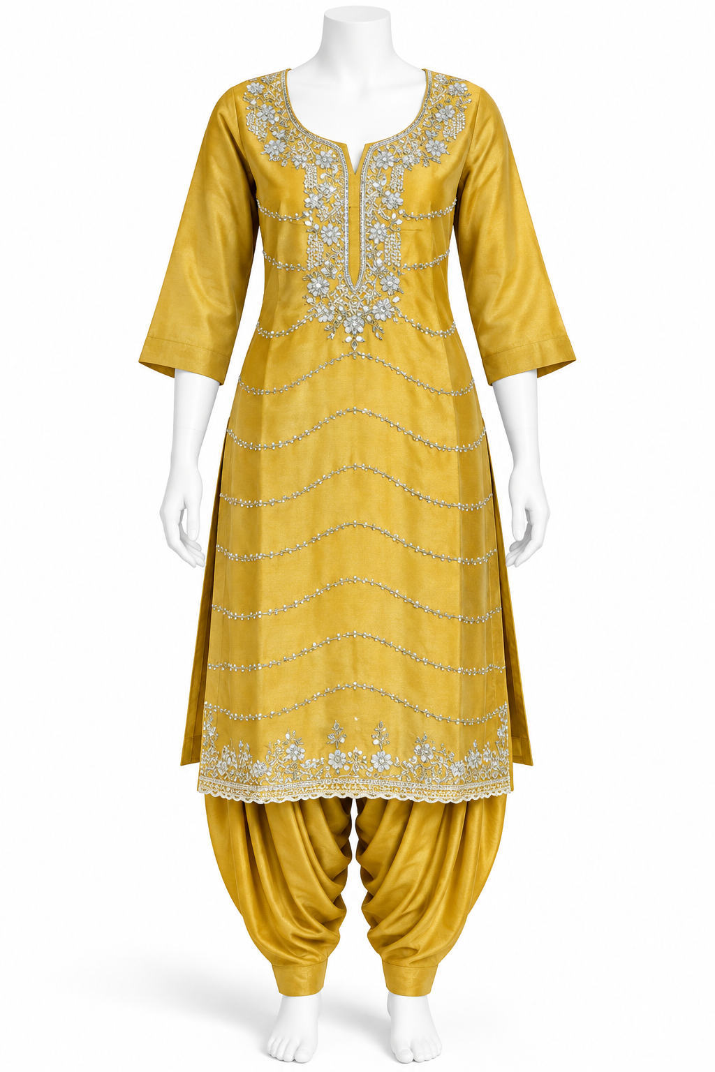 A mustard yellow traditional Indian outfit displayed on a white mannequin, featuring a kurta with silver mirror-work embroidery and matching harem pants.