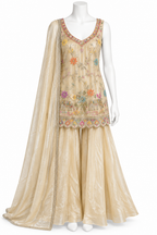 A beige three-piece traditional outfit displayed on a white mannequin, featuring a heavily embroidered floral V-neck top, matching wide-leg pants, and a sheer draped dupatta.