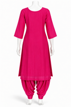 A bright pink traditional kurta set displayed on a white mannequin, featuring a three-quarter sleeve straight kurta and matching gathered patola-style pants against a plain white background.