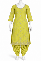 A three-piece Indian ethnic suit set displayed on a white mannequin, featuring a lime green kurta with silver embroidery, matching harem pants, and a coordinating belt.