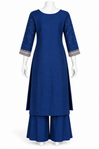 A royal blue three-piece kurta set displayed on a white mannequin, featuring a straight-neck long kurta with three-quarter sleeves decorated with small gold dots and a patterned border, matching flared pants, and a coordinating belt.