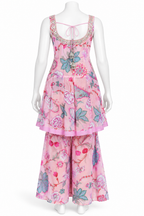 A pink floral two-piece set displayed on a white mannequin, featuring a sleeveless top with a tie neckline and matching wide-leg pants.