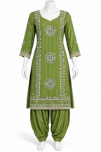 An olive green three-piece traditional Indian salwar kameez suit displayed on a white mannequin. The set includes a long-sleeved embroidered kameez tunic with intricate silver and white geometric patterns, paired with matching olive green patina pants.