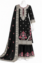 A black three-piece traditional South Asian outfit set displayed on a white mannequin, featuring a long kurta with silver and pink floral embroidery, matching flared sharara pants, and a coordinating dupatta.
