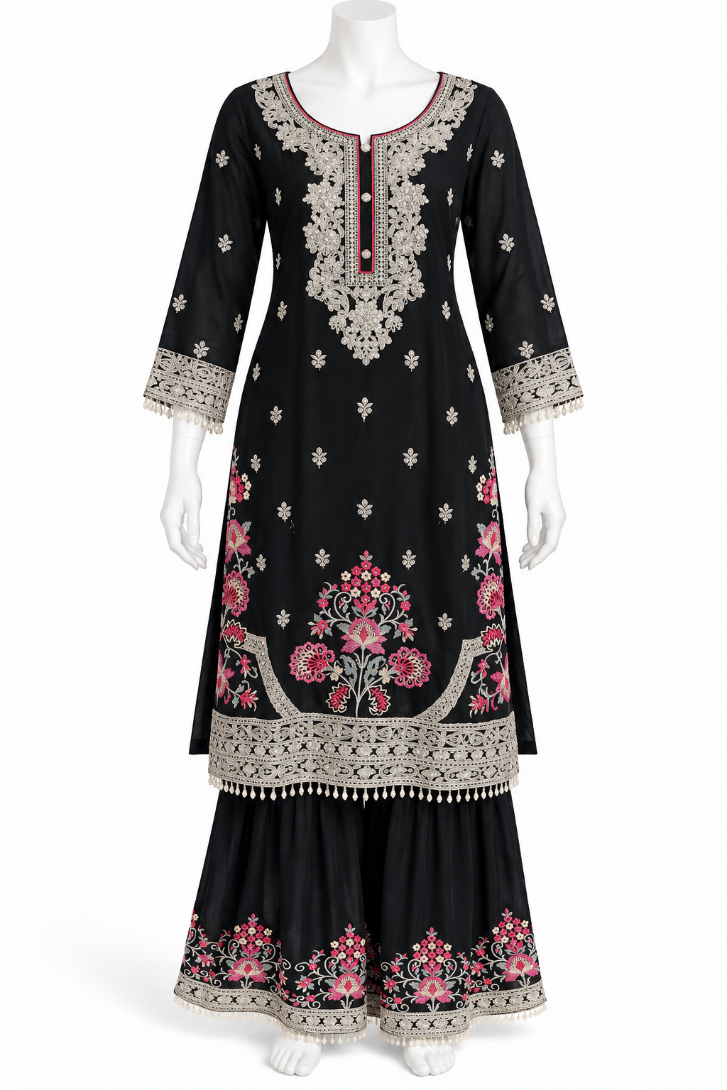 A black three-piece traditional Indian outfit displayed on a white mannequin, featuring a long kurta with pink floral embroidery, a matching flared sharara pant, and a wide border skirt with detailed silver and pink embroidery.