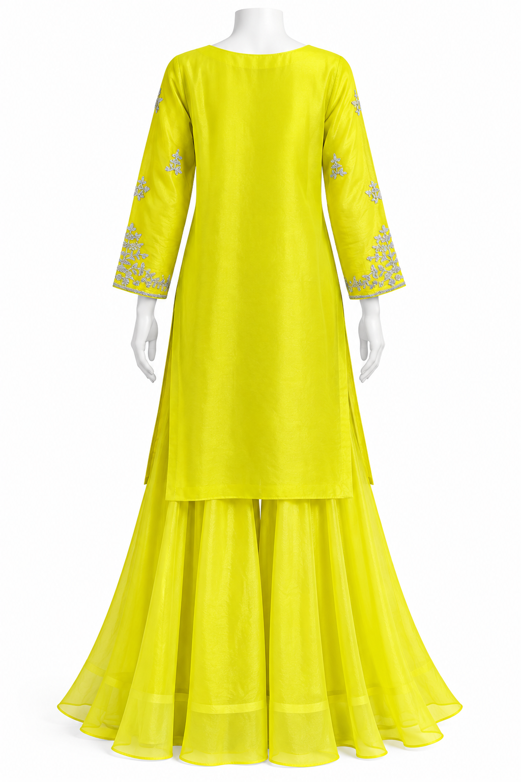 A bright yellow three-piece traditional outfit displayed on a white mannequin, featuring a long-sleeve kurta with silver embroidery on the cuffs, matching flared pants, and a layered skirt, set against a plain white background.