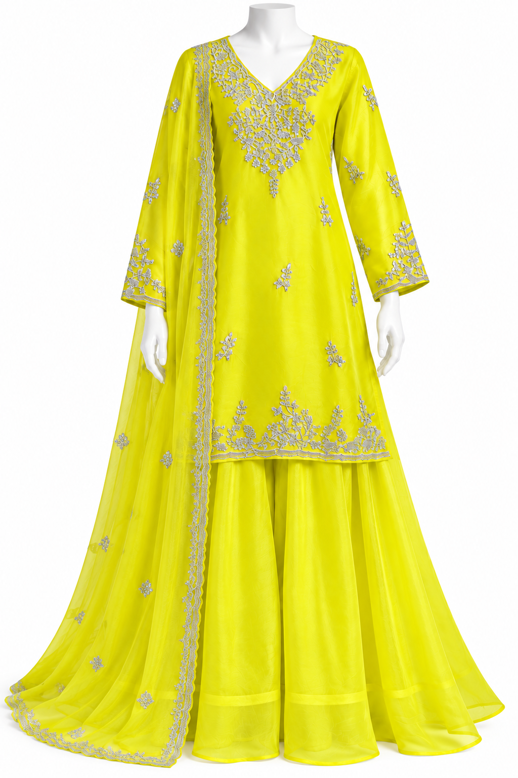 A bright yellow traditional Indian outfit displayed on a white mannequin, featuring a long kurta with silver embroidery, matching flared pants, and a sheer dupatta draped over one shoulder.