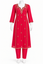 A bright pinkish-red three-piece kurta set displayed on a white mannequin, featuring a long tunic with gold embroidery, matching pants, and a coordinating collar.