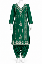 A green traditional Indian salwar kameez set displayed on a white mannequin. The kurta features intricate silver mirror embroidery along the neckline, front panels, and hem, paired with matching green patina pants.