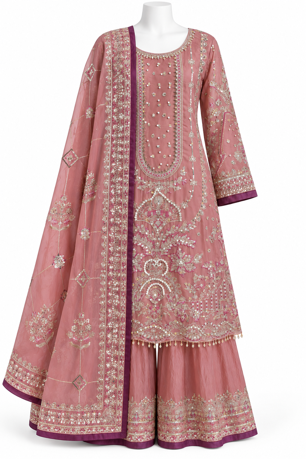 A pink traditional Indian outfit with intricate silver and gold embroidery, featuring a long kurta, matching flared pants, and a draped dupatta, displayed on a white mannequin against a white background.