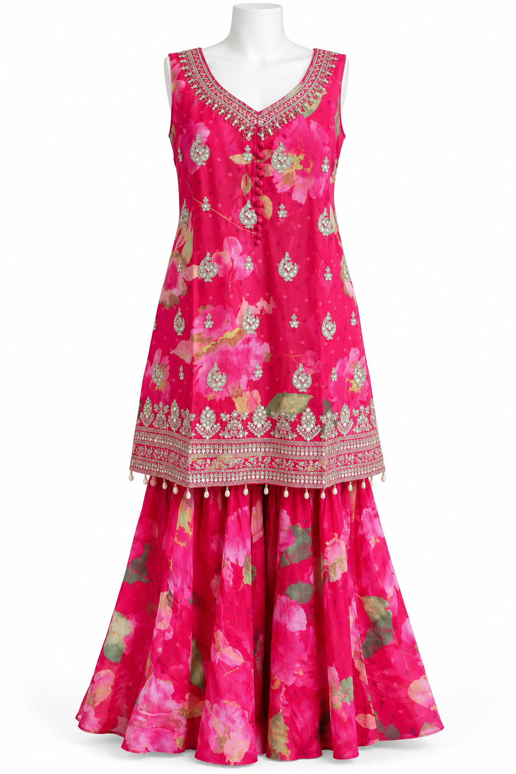 A sleeveless magenta pink traditional dress with a floral print and ornate gold embroidery, displayed on a white mannequin against a white background.