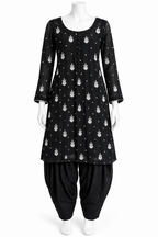 A black three-quarter sleeve kurta with a white printed pattern, paired with black patola pants, displayed on a white mannequin against a plain white background.