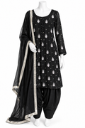 A black three-piece traditional outfit displayed on a white mannequin, featuring a kurta with white motifs, black patola pants, and a matching black dupatta with a silver border.