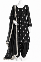 A black three-piece traditional outfit displayed on a white mannequin, featuring a kurta with white motifs, black patola pants, and a matching black dupatta with a silver border.