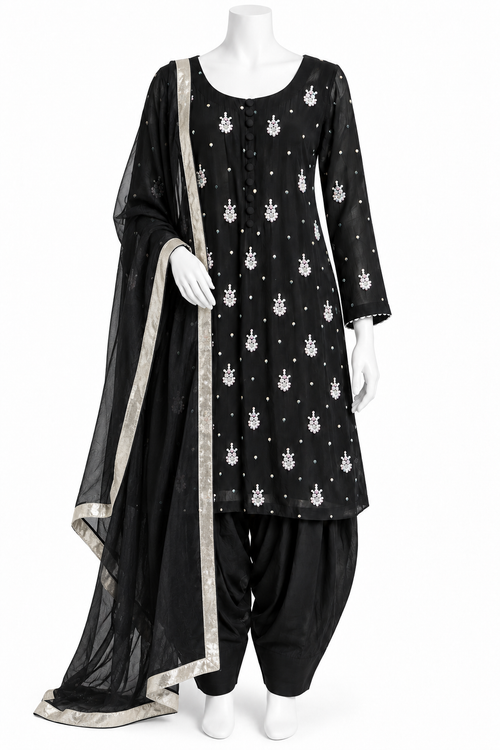 A black three-piece traditional outfit displayed on a white mannequin, featuring a kurta with white motifs, black patola pants, and a matching black dupatta with a silver border.
