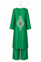 Green outfit with intricate embroidery on a white background
