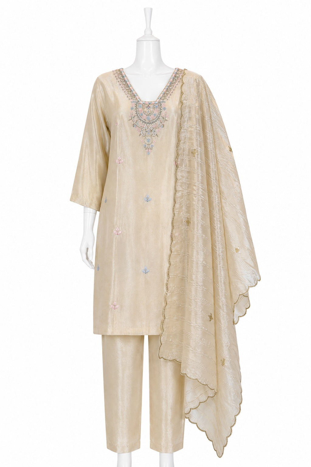 Beige embroidered traditional outfit on a mannequin against a white background