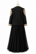 Black dress with gold embroidery on sleeves and hem on a mannequin against a white background