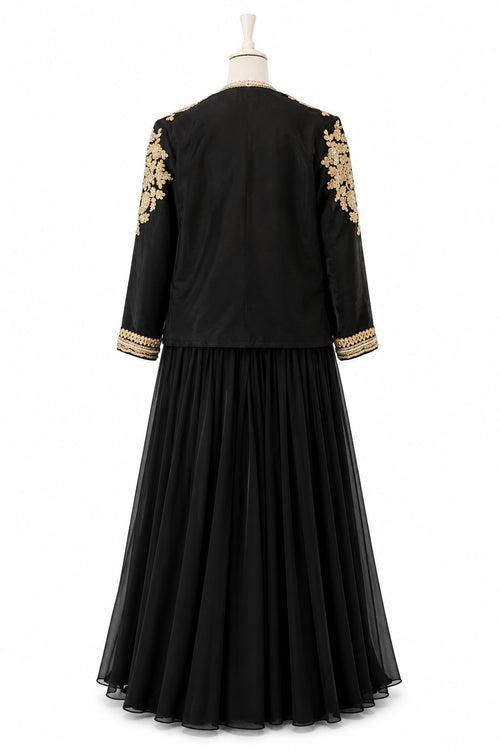 Black dress with gold embroidery on sleeves and hem on a mannequin against a white background