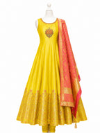 Yellow anarkali suit with a red dupatta on a mannequin against a white background