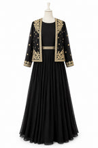 Black dress with gold embroidery on a mannequin against a white background