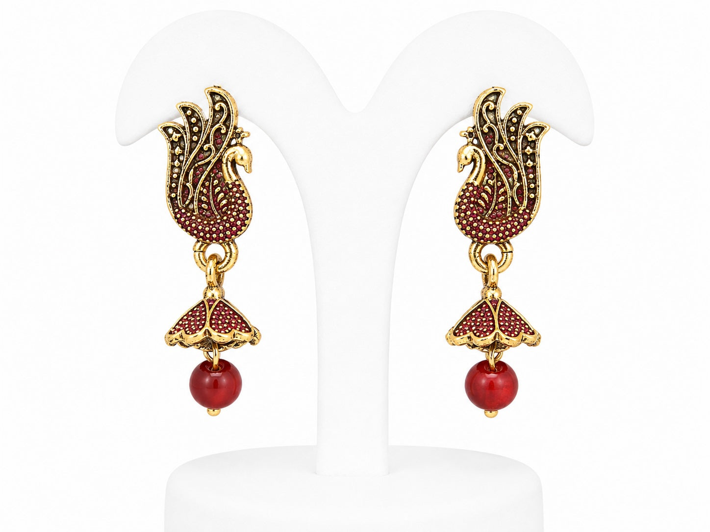 Pair of gold and red earrings on a white background