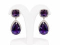 Pair of purple teardrop earrings on a white stand