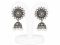 Pair of silver and pearl earrings on a white stand