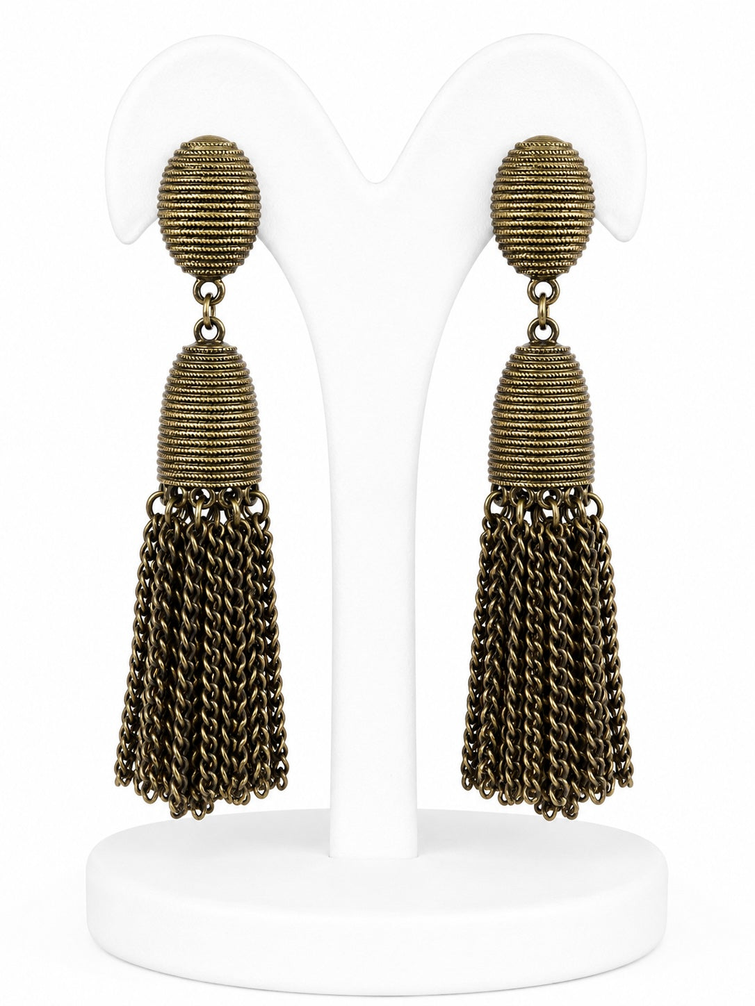 Pair of gold tassel earrings on a white stand