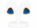 Teal earrings with gold accents on a white stand
