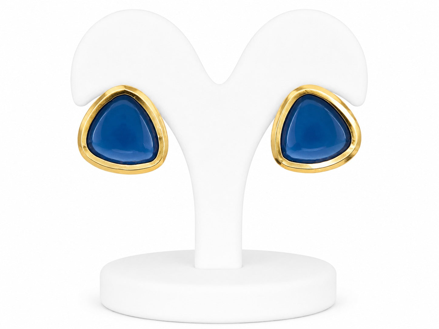 Teal earrings with gold accents on a white stand
