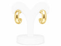 Gold hoop earrings on a white stand with a white background