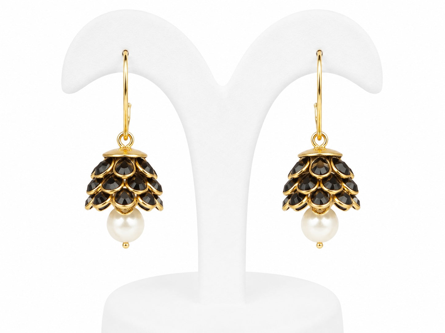 Pair of earrings with black gemstones and pearl drops on a white background