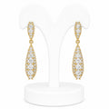 Gold earrings with clear stones on a white stand