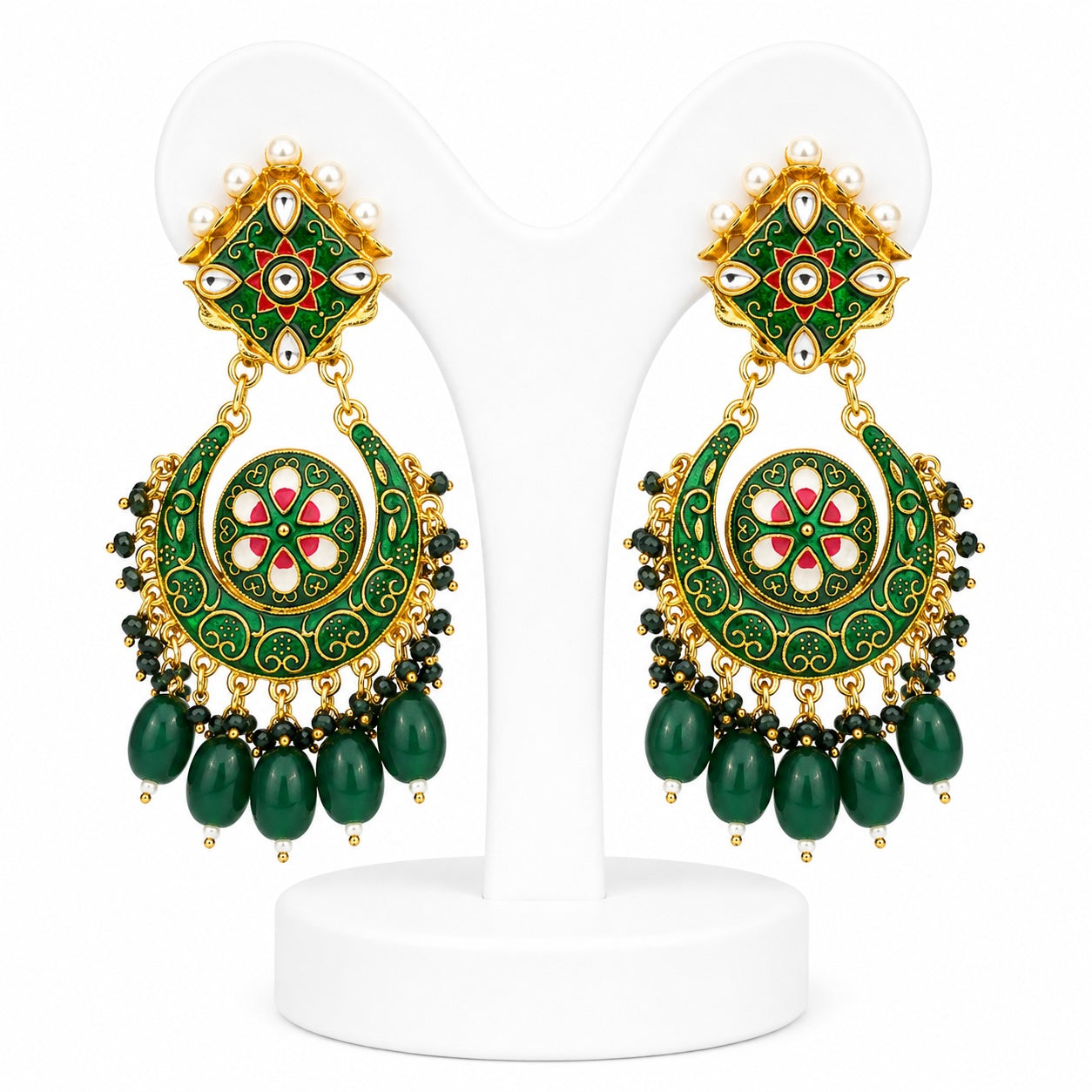 Pair of green and gold earrings on a white stand