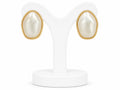 Pair of pearl earrings with gold accents on a white stand.
