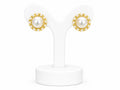 Pair of pearl earrings with gold accents on a white stand